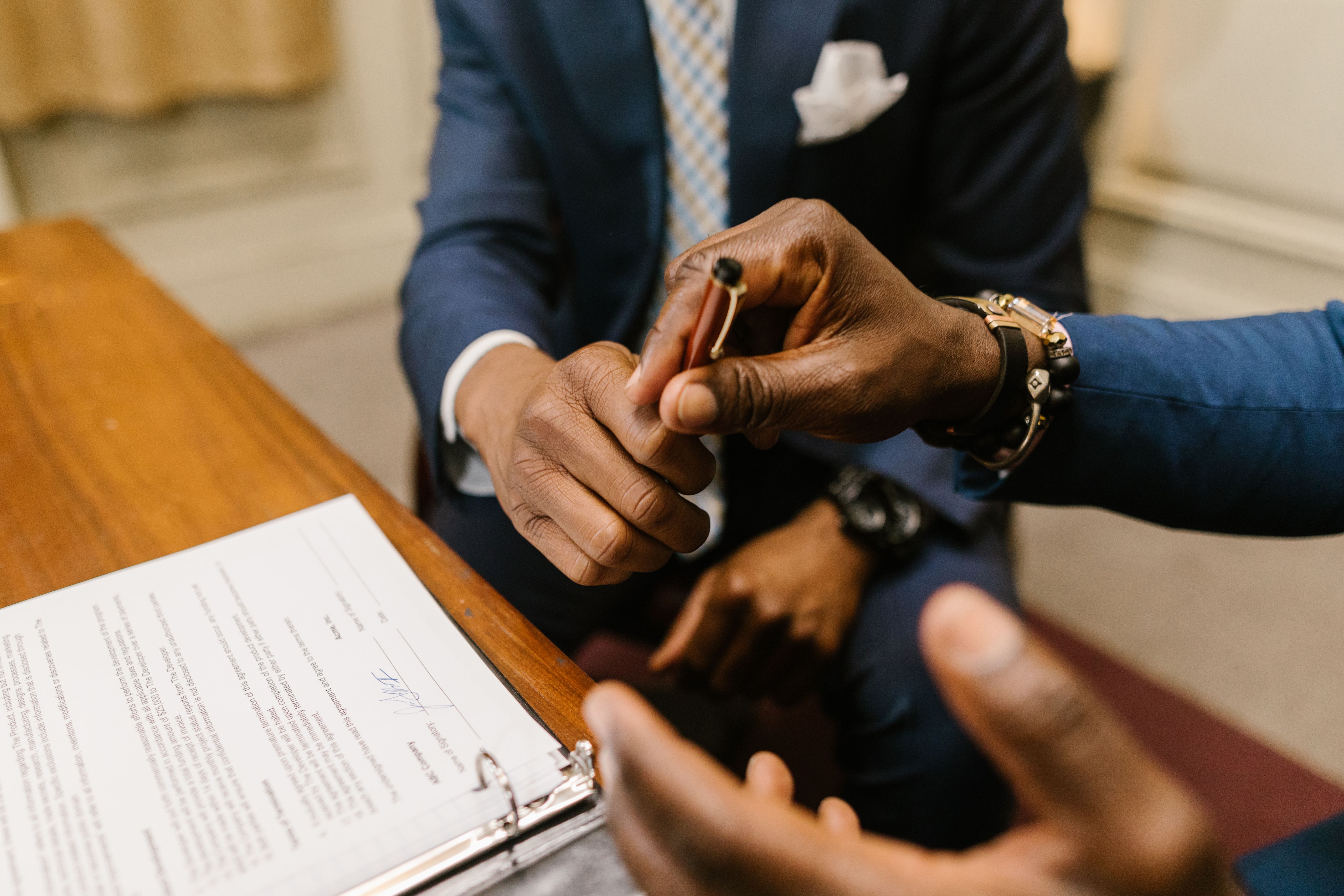 Businessmen signing a contract, representing brand deals that can be canceled over Taiwan comments